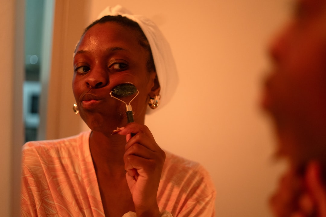 Woman rubbing her facce with an anti-wrinkle tool